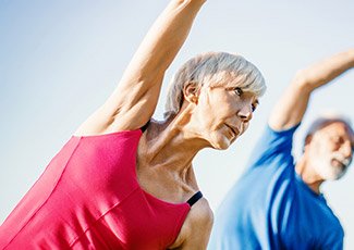 Two people stretching outside